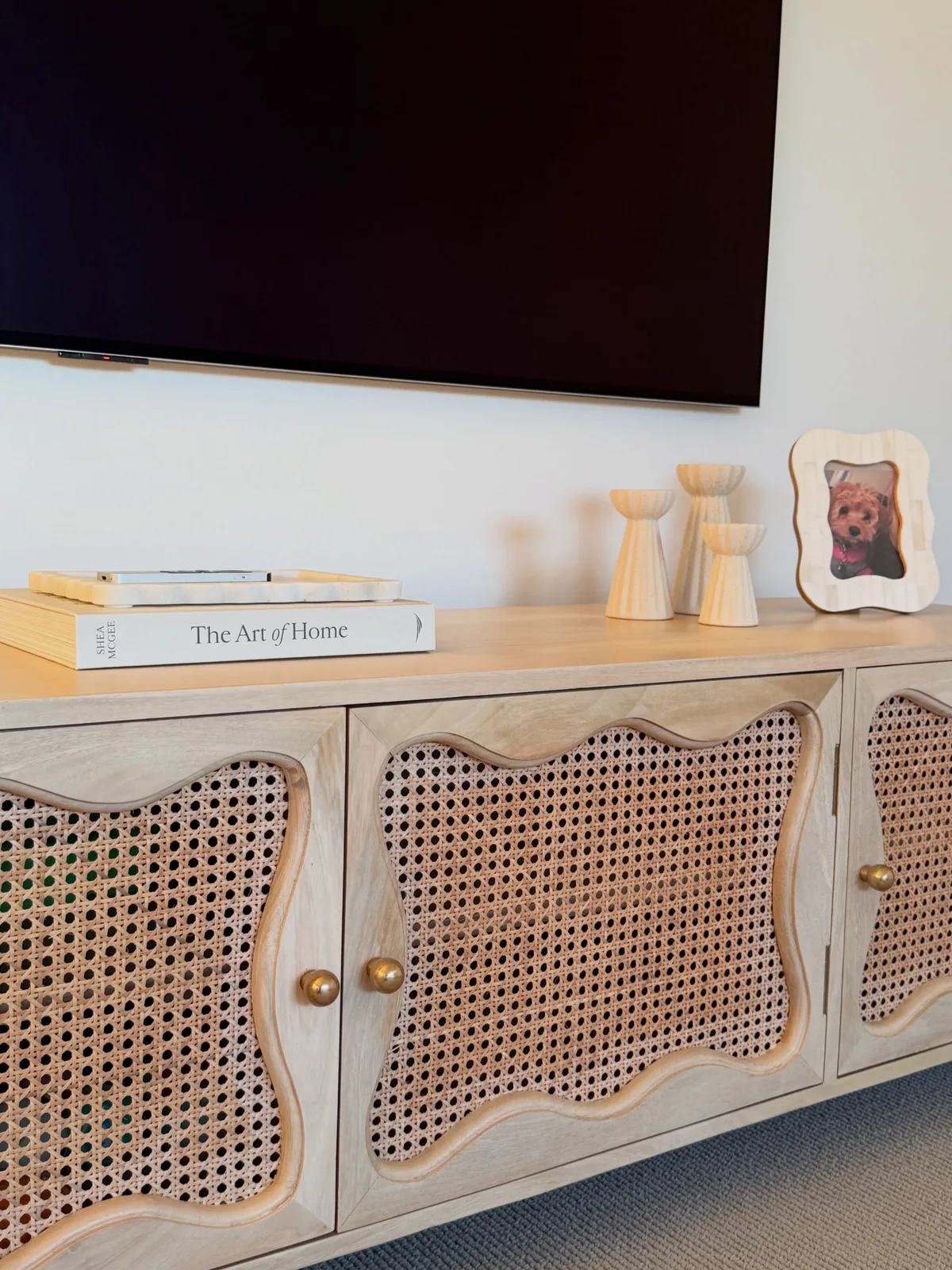 James Lane Baxter TV unit with curved rattan door panels and brass-coloured knobs