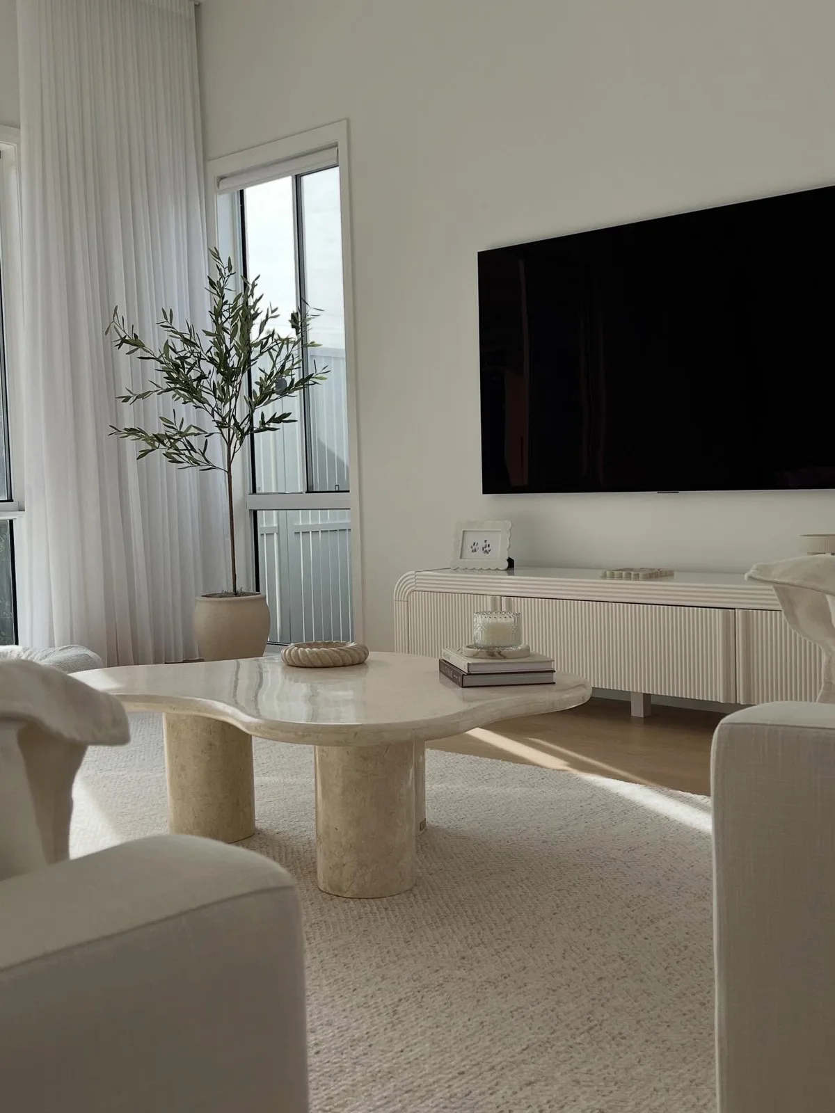 Organic-shaped cream stone coffee table in our neutral living room