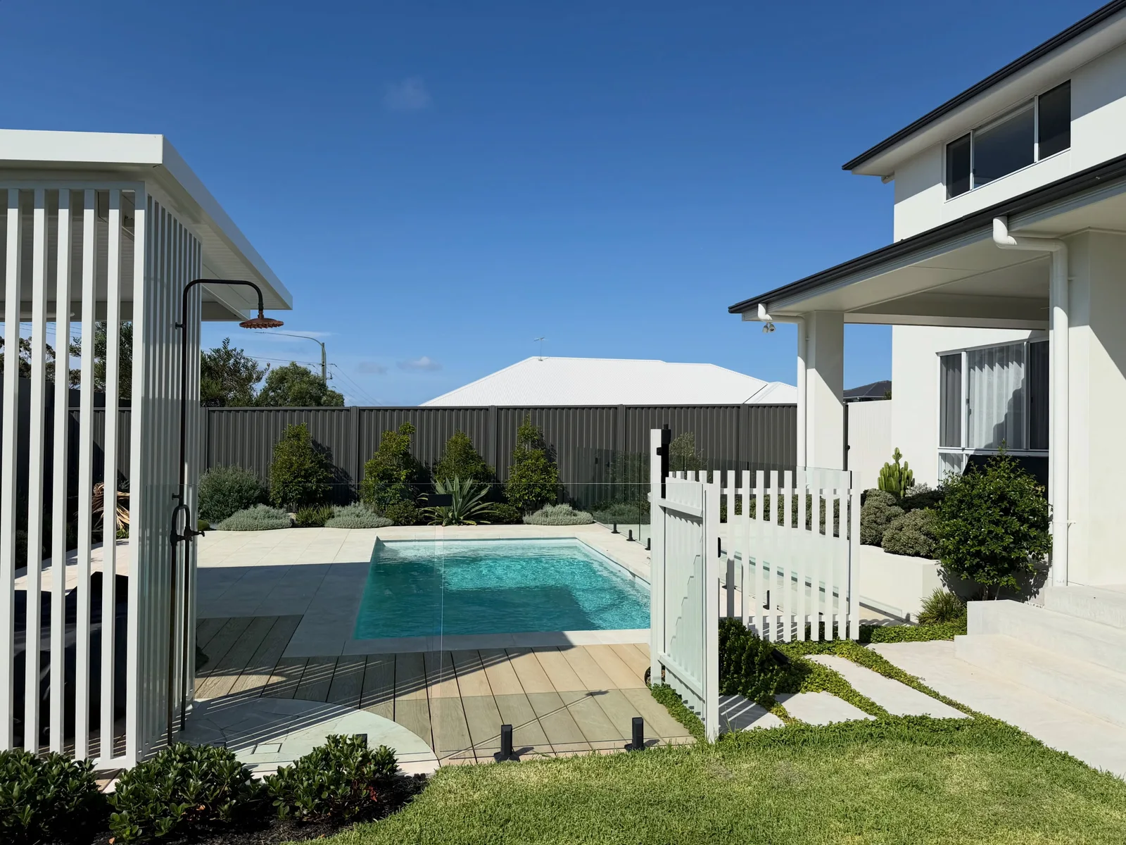 Our swimming pool, garden and white poolside pavilion